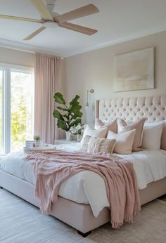 a bedroom with a large bed and pink blankets