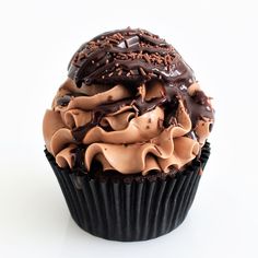 a cupcake with chocolate frosting and sprinkles on it's top