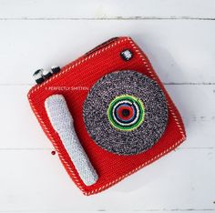 a small red case with a circular design on it