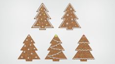 four christmas trees made out of gingerbread on a white surface with snow flakes