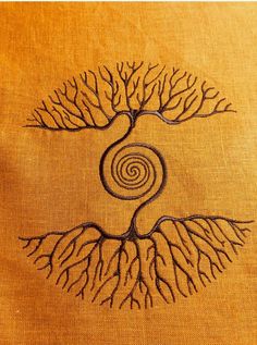 a tree with its roots in the shape of a spiral on a piece of cloth