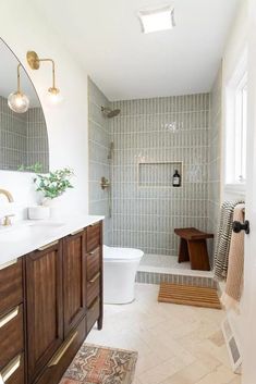 a bathroom with a toilet, sink and mirror