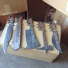 five knives sitting on top of a box next to each other in different sizes and shapes