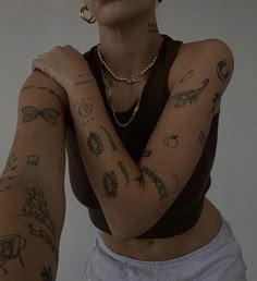 a woman with many tattoos on her arms