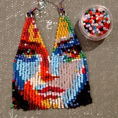 a pair of earrings made out of beads