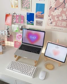 an open laptop computer sitting on top of a white desk