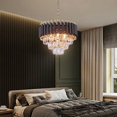 a bedroom with a large bed and chandelier hanging from the ceiling