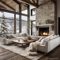 a living room filled with furniture and a fire place in front of a large window