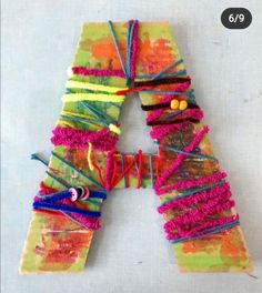 the letters are made out of yarn and thread