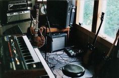 a room with guitars, amps and other musical equipment