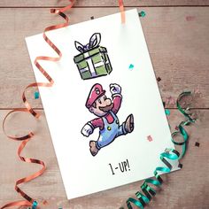 a birthday card with an image of a nintendo character holding a gift box and confetti streamers