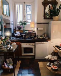 a kitchen filled with lots of clutter and dishes