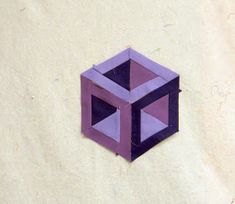 an origami cube is shown on a white wall with purple and black squares