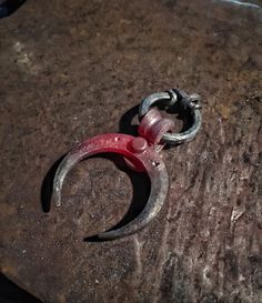 a pair of scissors sitting on top of a rock