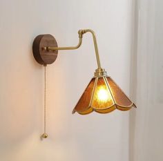 a wall mounted light with a lamp attached to it's side next to a door