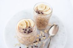 two small jars filled with oatmeal and banana slices on top of each other