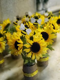 sunflowers in vases with bees on them