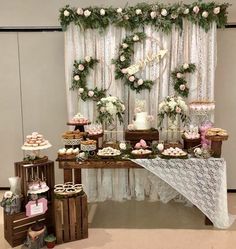 the dessert table is decorated with flowers and greenery