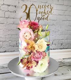 there is a cake with flowers on it and the words 30 never looked so good