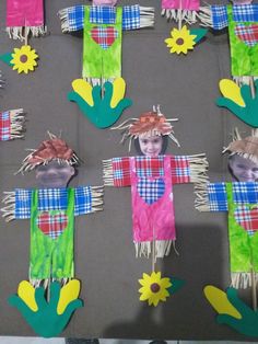 paper scarecrows are displayed on a table