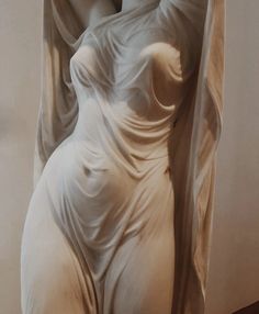 a statue is shown in the shape of a woman's body with her hands on her head