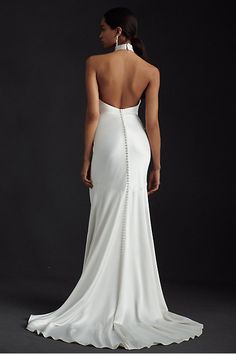 the back of a woman's white wedding dress