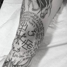 a person with a tattoo on their leg and some writing on the side of his arm