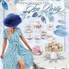 a woman in a blue dress and hat standing next to a table with tea cups on it