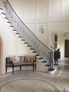 a large foyer with a staircase and two couches