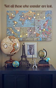 an image of a map on the wall above a table with books and other items