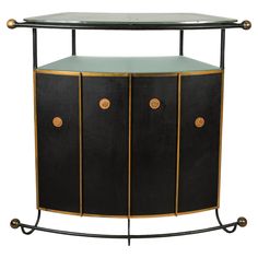 a black and gold cabinet with three doors on it's sides, one door open to the other side