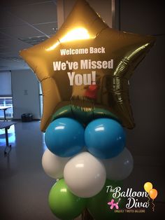 balloons and stars are on display in an office lobby