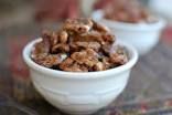 two white bowls filled with nuts on top of a table