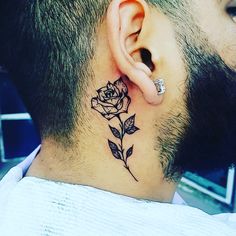 a man with a tattoo on his neck and behind the ear is a single rose