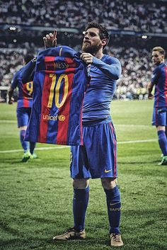 the soccer player is holding up his jersey in front of other players on the field