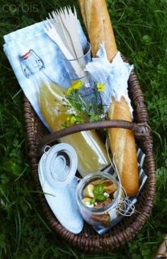 a picnic basket filled with food and drinks