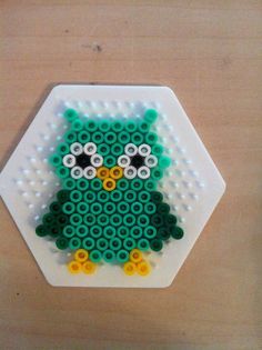 an owl made out of legos sitting on top of a table