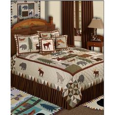 the bed is made up with brown and white quilts on it, along with an animal themed comforter