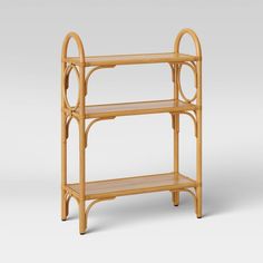 a bamboo shelf with two shelves on each side and an oval design at the top