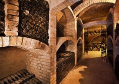 an old wine cellar with many bottles in it