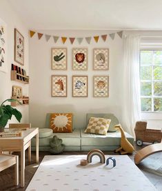 a living room filled with furniture and pictures on the wall