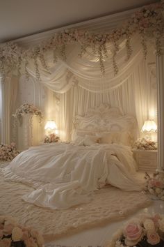 a white bed sitting under a canopy covered in flowers