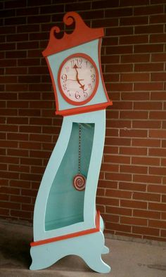 a clock that is on the side of a brick wall in front of a building