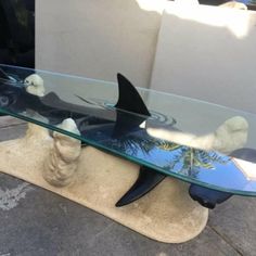 a glass table that has a shark on it