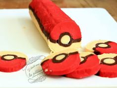 there is a cake shaped like a red car on the white plate with other cookies