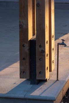 a wooden sculpture sitting on top of a sidewalk