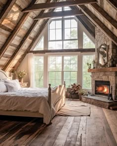 a bedroom with a bed, fireplace and large windows in the ceiling is made out of wood planks