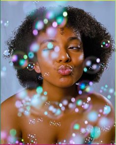 a woman blowing bubbles in front of her face with the caption's name on it