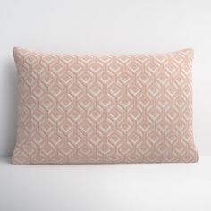 a pink pillow on a white surface