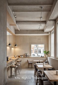 an empty restaurant with wooden tables and chairs